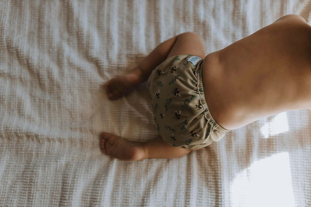 A baby wearing a Bayrli Everyday pocket cloth diaper